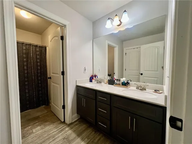 a bathroom with a double vanity sink and mirror