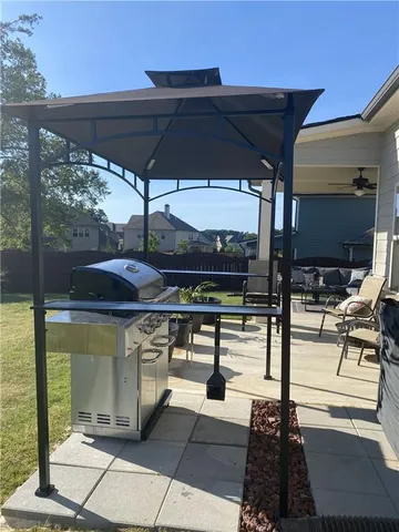 a view of a patio with table and chairs under an umbrella