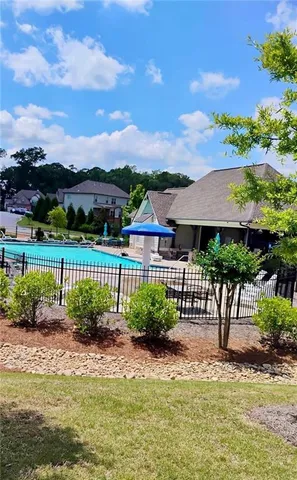 a view of a garden with a house in the background
