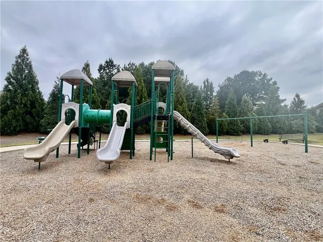 a view of outdoor space with playground and green space