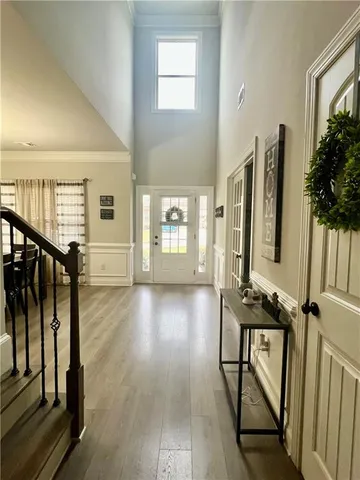 a view of an entryway with wooden floor and door
