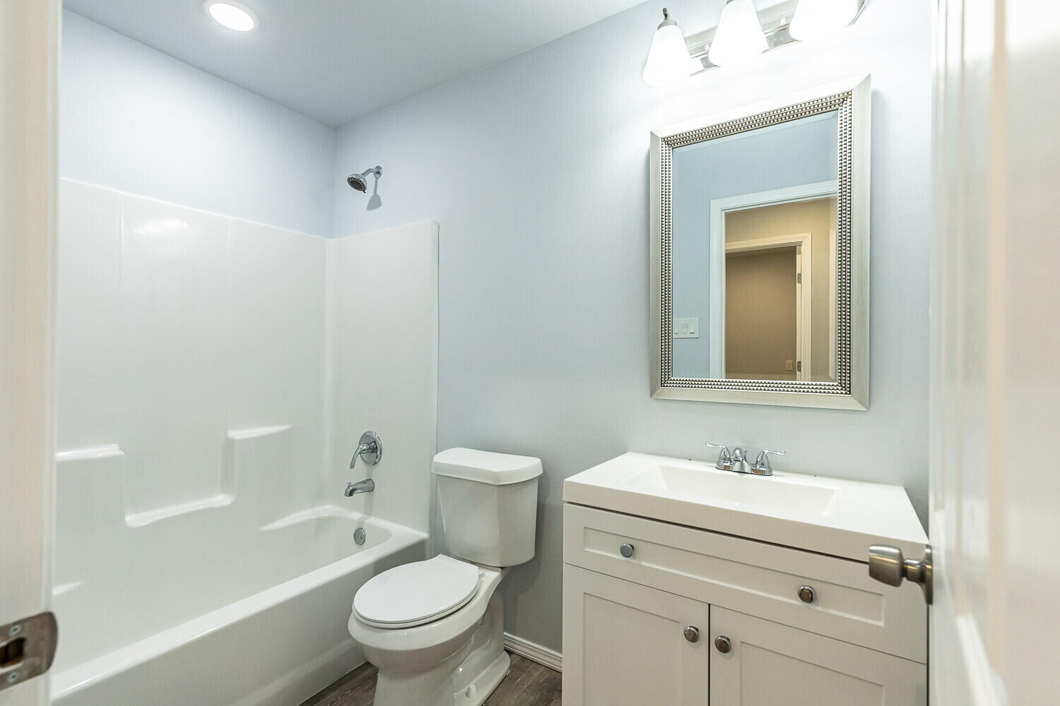 1104 North Englewood Avenue, Unit B Lubbock, TX 79416 - Photo 11 of 11 a bathroom with a sink a toilet and a mirror