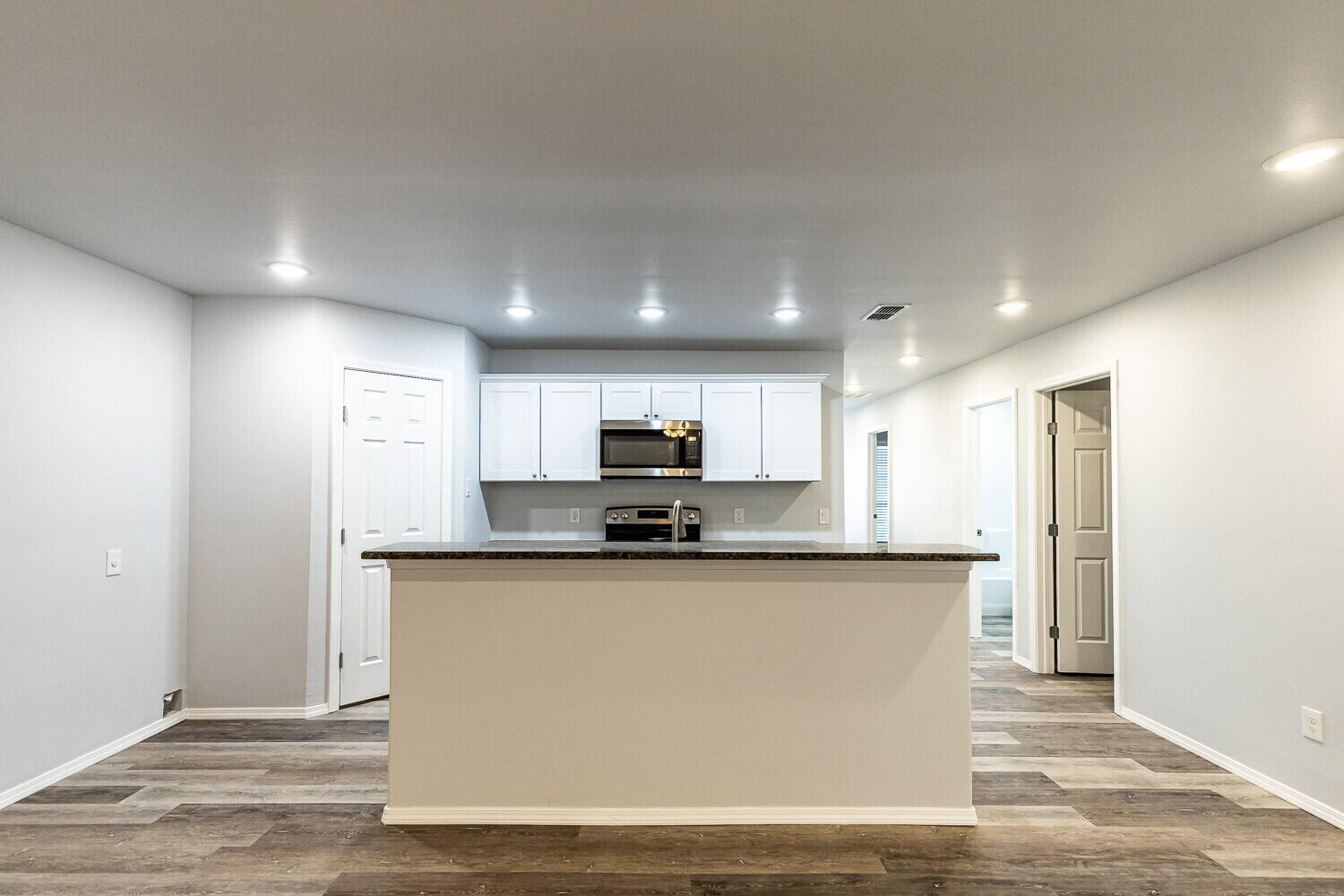 1104 North Englewood Avenue, Unit B Lubbock, TX 79416 - Photo 4 of 11 a kitchen with stainless steel appliances granite countertop a sink and a refrigerator