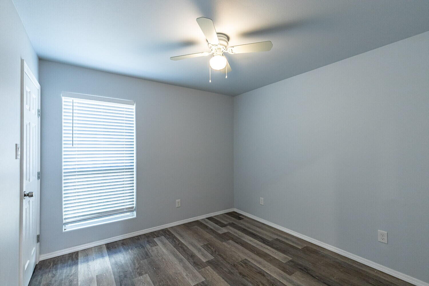 1104 North Englewood Avenue, Unit B Lubbock, TX 79416 - Photo 8 of 11 an empty room with a window and wooden floor