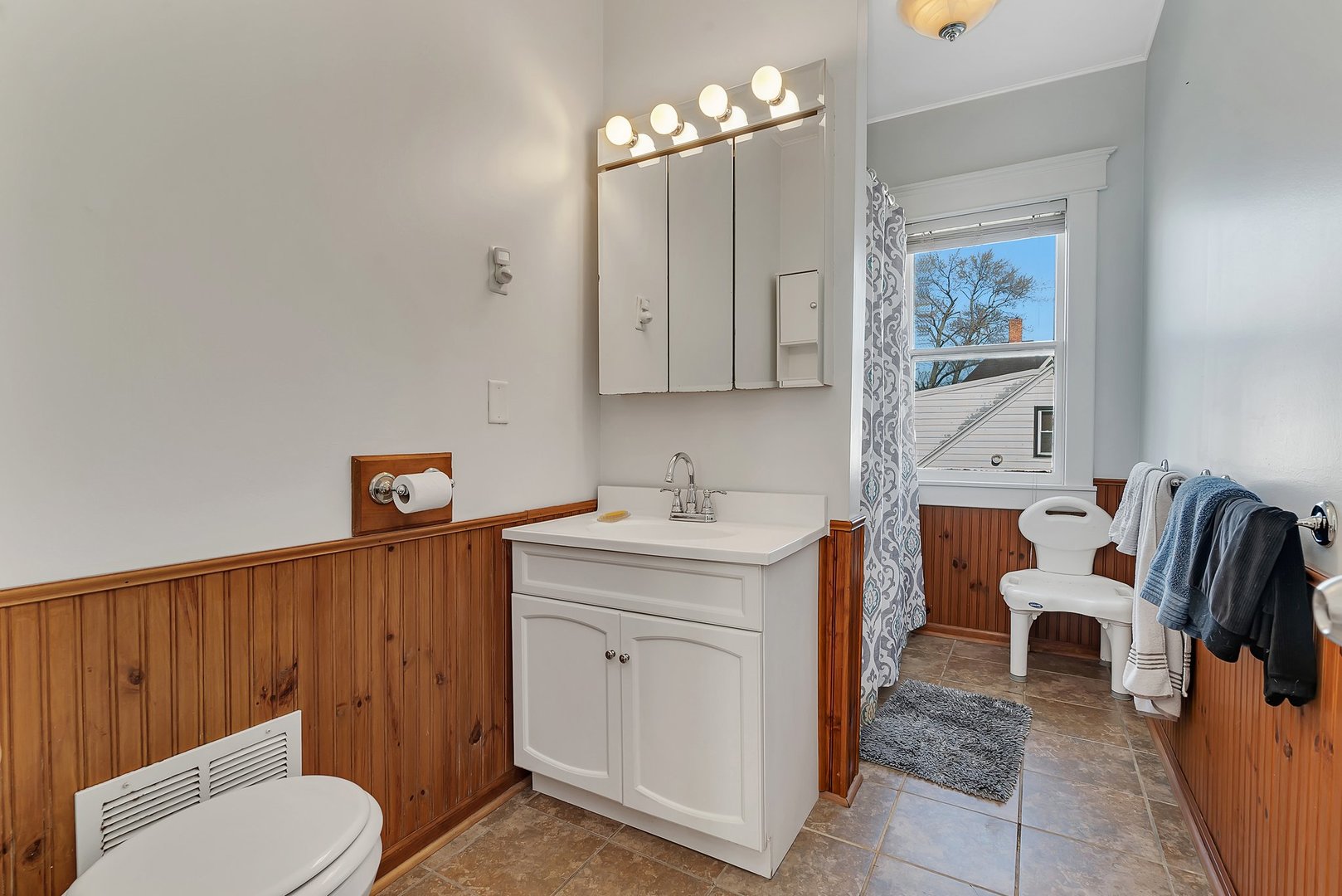 401 7th Street Mazon, IL 60444 - Photo 16 of 26 a spacious bathroom with a toilet a sink and a mirror