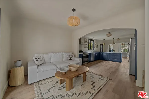 a living room with furniture a rug and a window