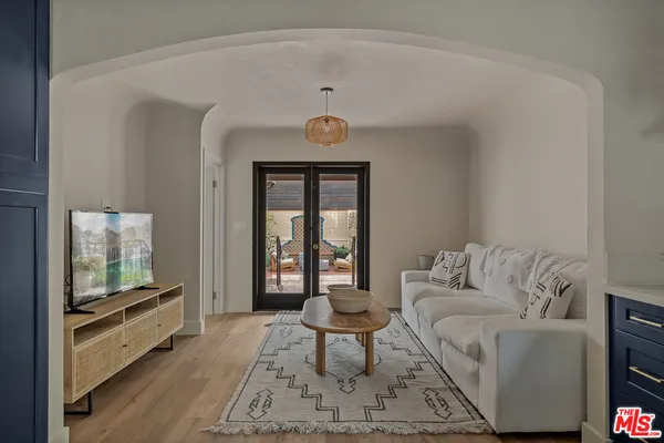 a bedroom with a bed and a potted plant