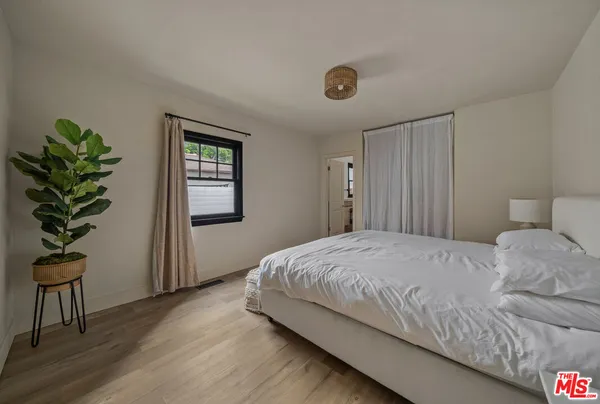 a bedroom with a bed and a view of bedroom