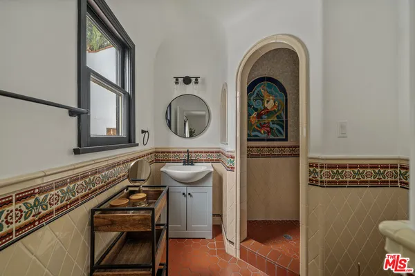 a bathroom with a toilet a sink and a mirror