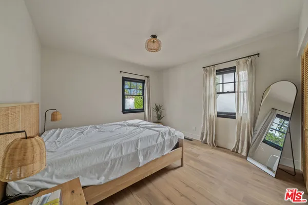 a bedroom with furniture and a window