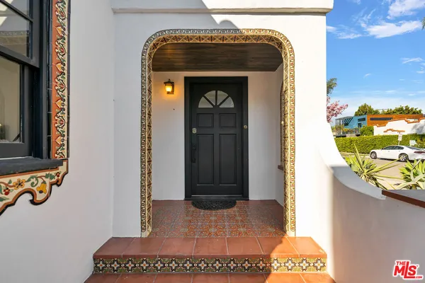 a living room with furniture a fireplace and a wooden floor