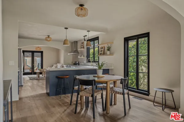 a kitchen with stainless steel appliances granite countertop a stove a sink dishwasher and a oven with cabinets