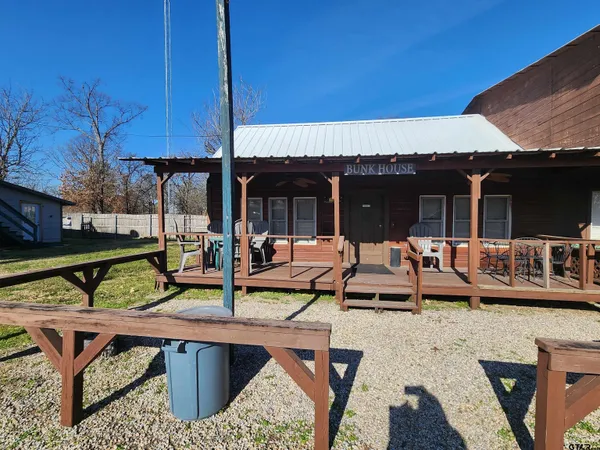 a view of a patio with table and chairs under an umbrella