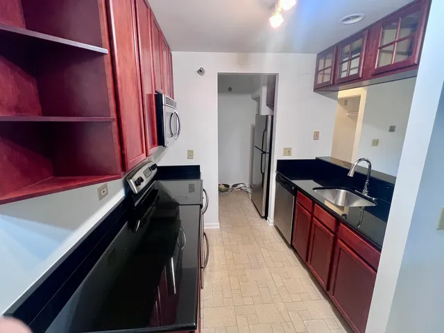 a kitchen with a sink stove and refrigerator