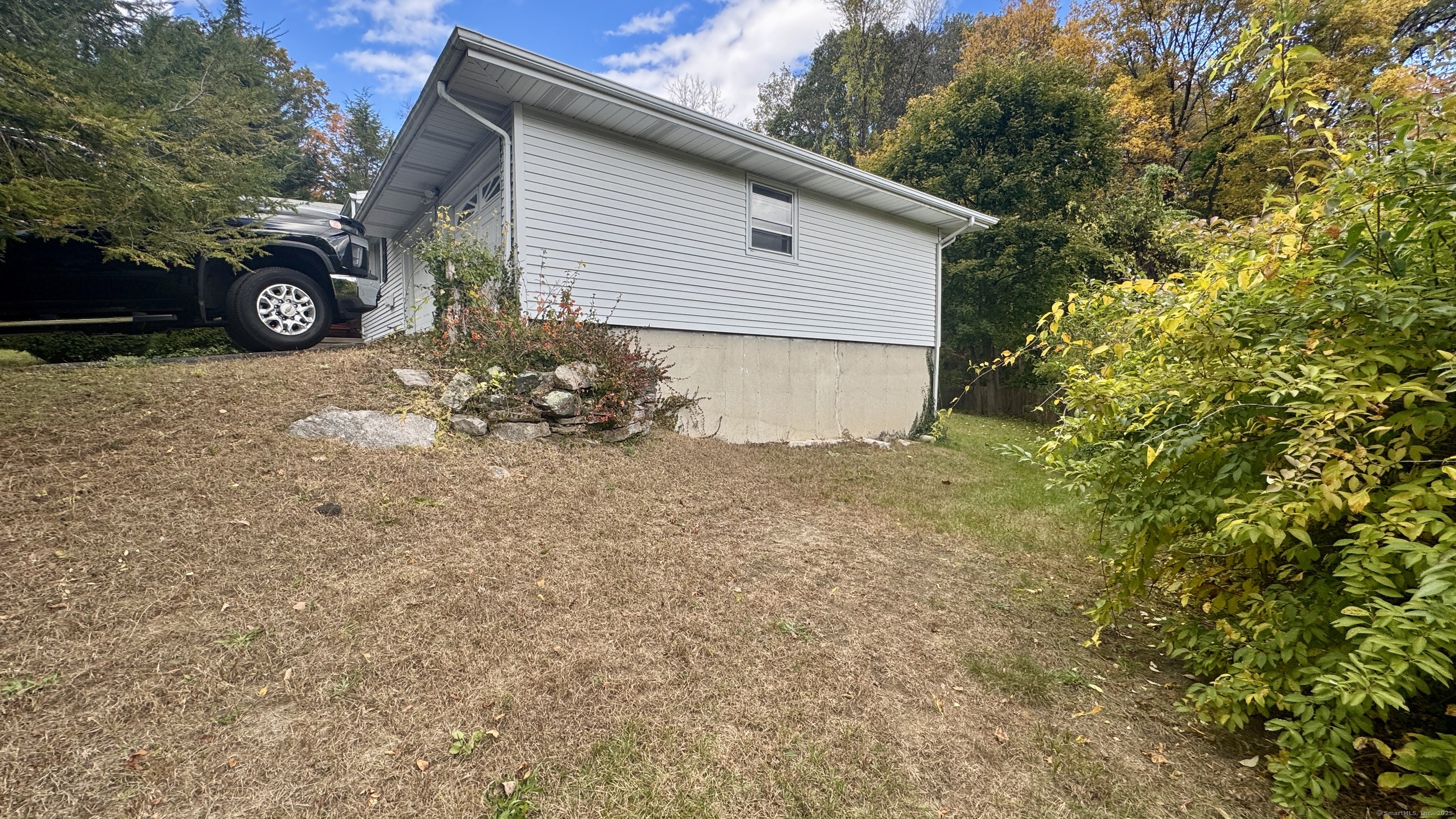 30 Mountain Road Danbury, CT 06810 - Photo 6 of 35 a backyard of a house with potted plants and large tree