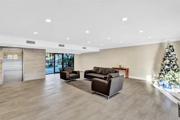 a living room with furniture and potted plants