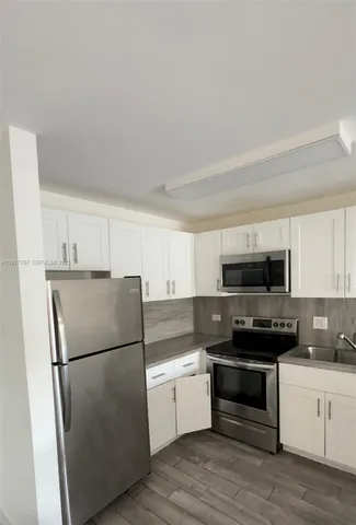 a kitchen with a refrigerator stove and microwave