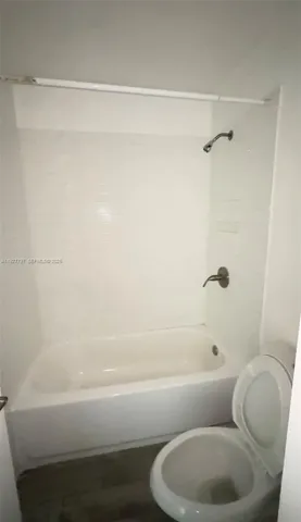 a bathroom with a toilet and a bathtub