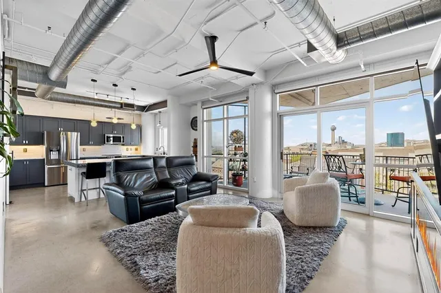 a living room with furniture ceiling fan and a rug