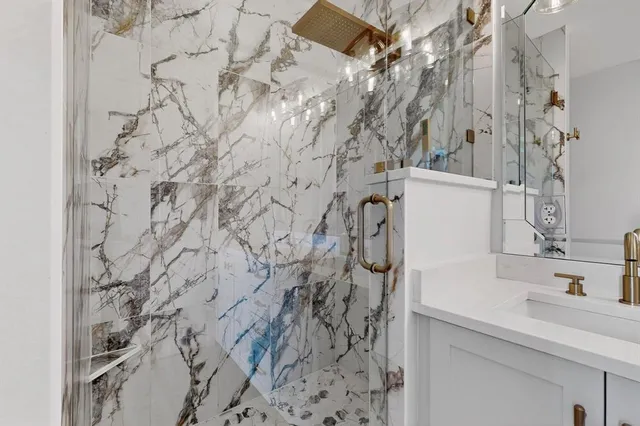 a bathroom with a shower and a sink