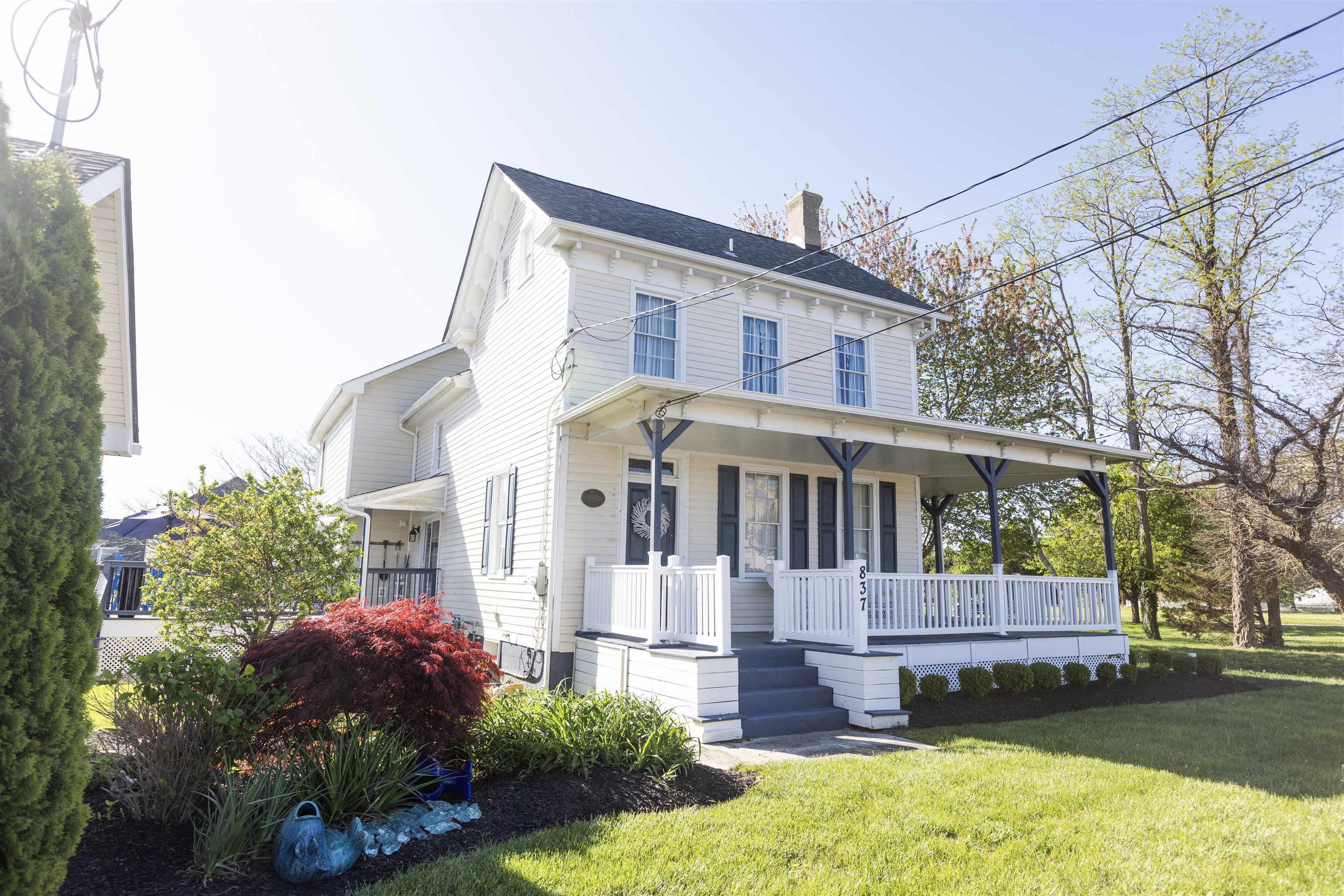 837 Seashore Road Cape May, NJ 08204 - Photo 1 of 47 a front view of a house with a garden