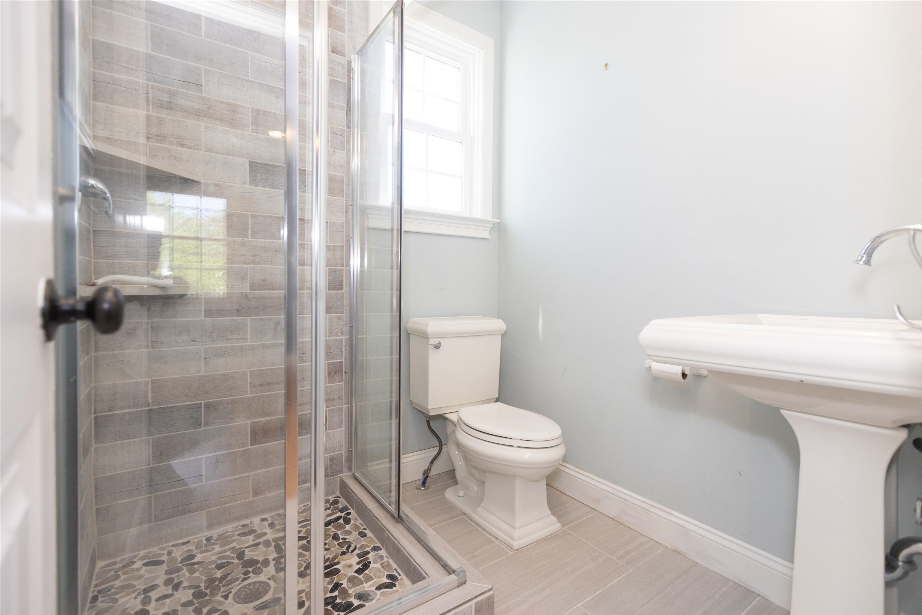 837 Seashore Road Cape May, NJ 08204 - Photo 30 of 47 a white toilet sitting next to a bathroom sink