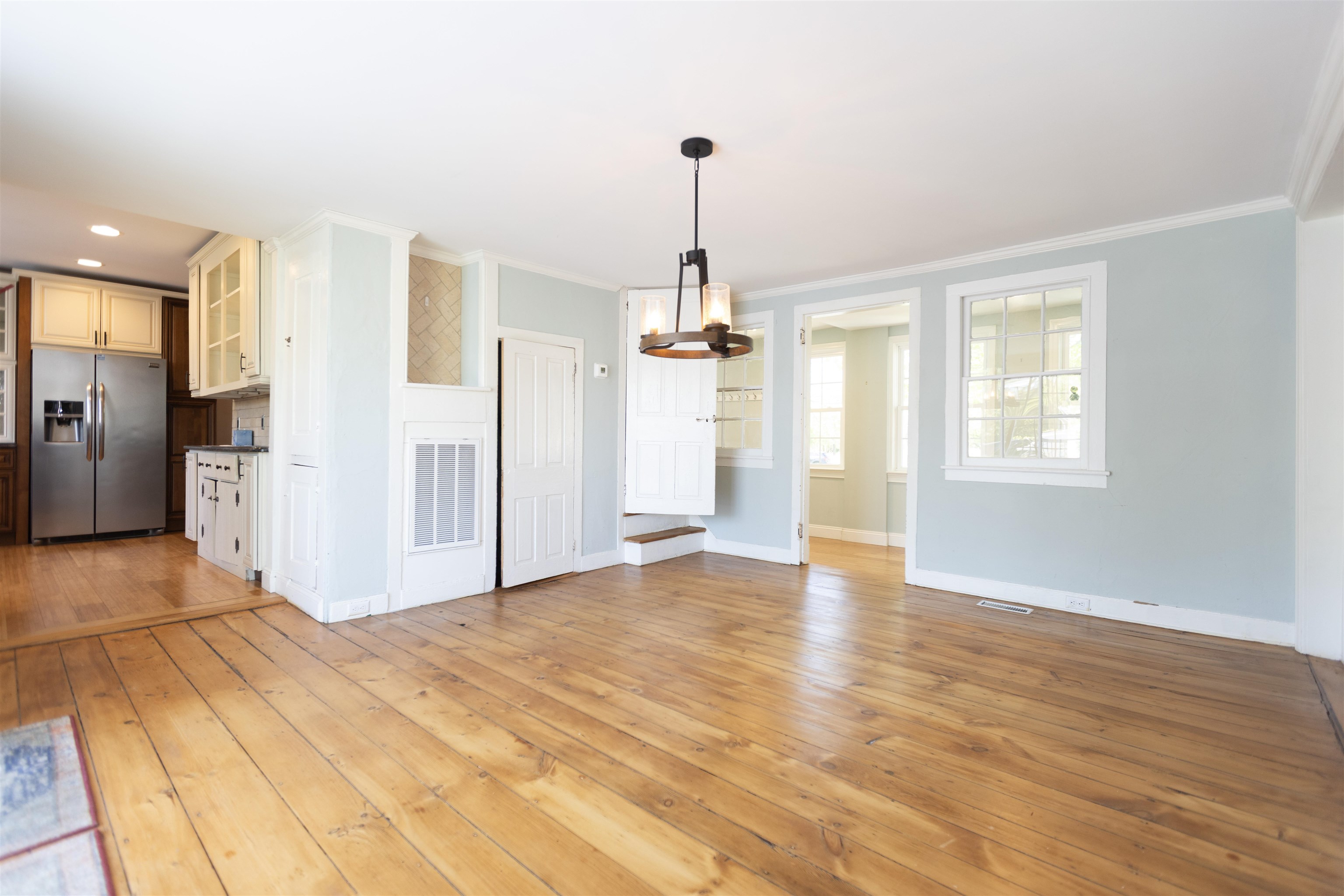 837 Seashore Road Cape May, NJ 08204 - Photo 8 of 47 a view of empty room with wooden floor and kitchen