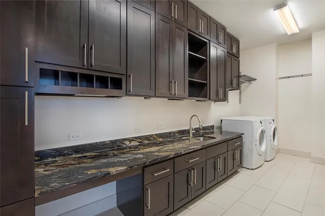 a kitchen with stainless steel appliances granite countertop a sink stove and microwave