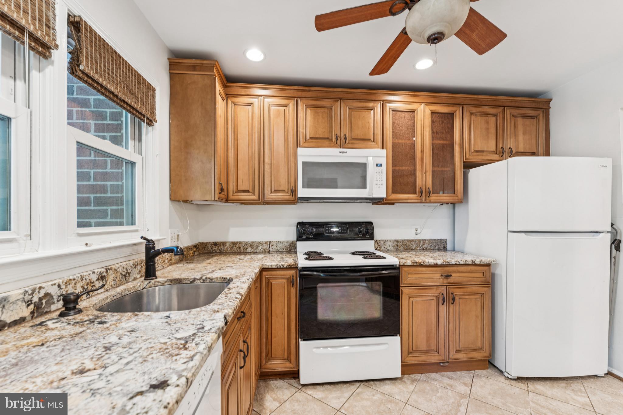 3152 B Covewood Court Falls Church, VA 22042 - Photo 4 of 26 a kitchen with stainless steel appliances granite countertop a sink stove and refrigerator