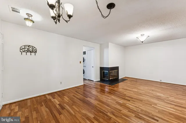 a view of a livingroom with a flesh screen tv and stairs