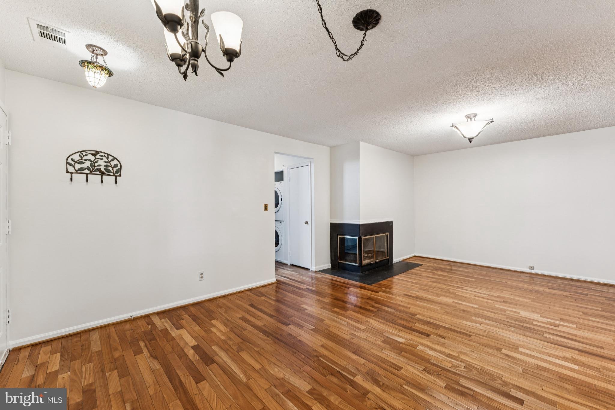 3152 B Covewood Court Falls Church, VA 22042 - Photo 6 of 26 a view of a livingroom with a flesh screen tv and stairs