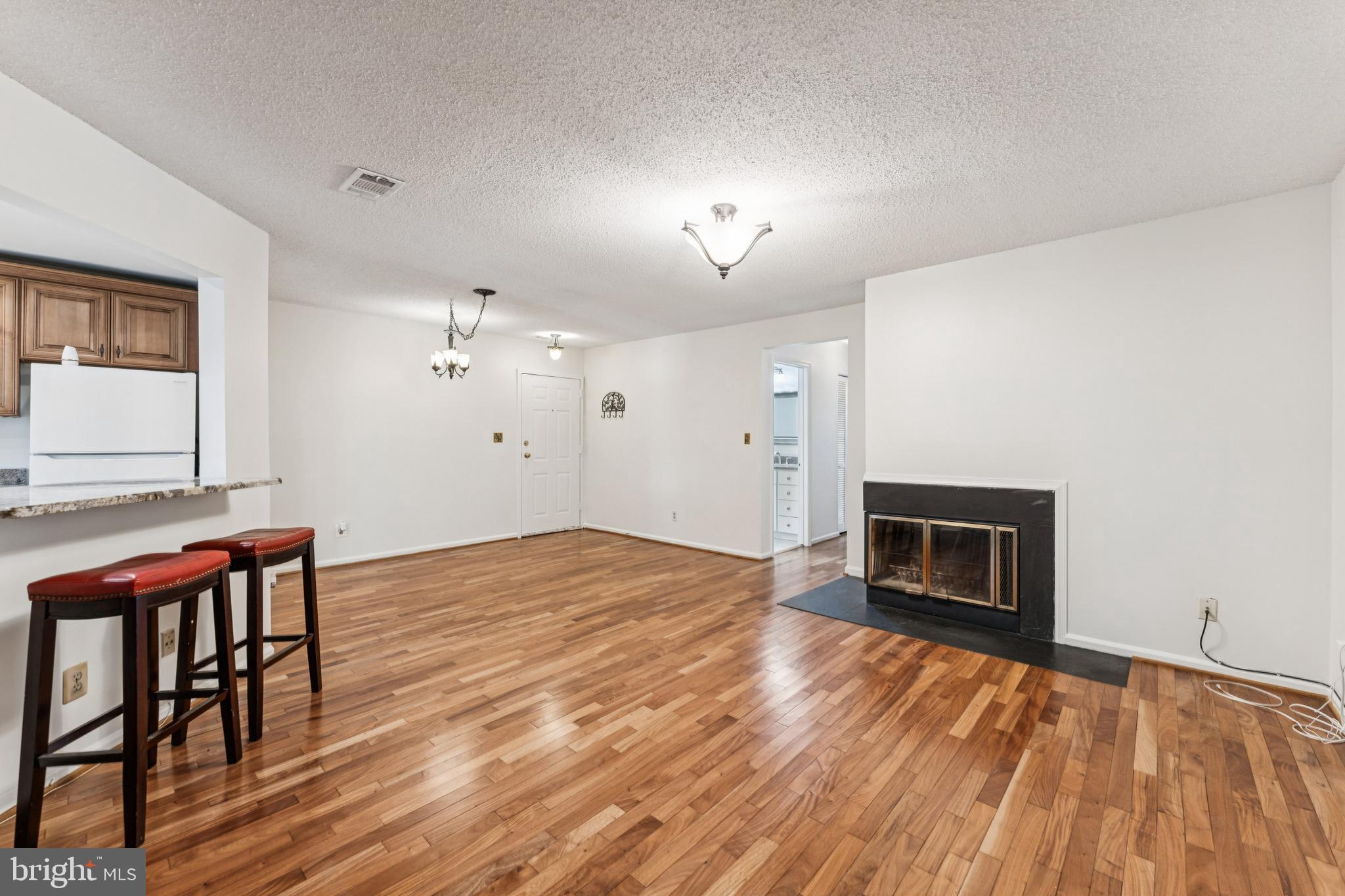3152 B Covewood Court Falls Church, VA 22042 - Photo 7 of 26 a view of empty room with wooden floor and fireplace