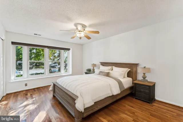 a large bedroom with a bed and a chandelier