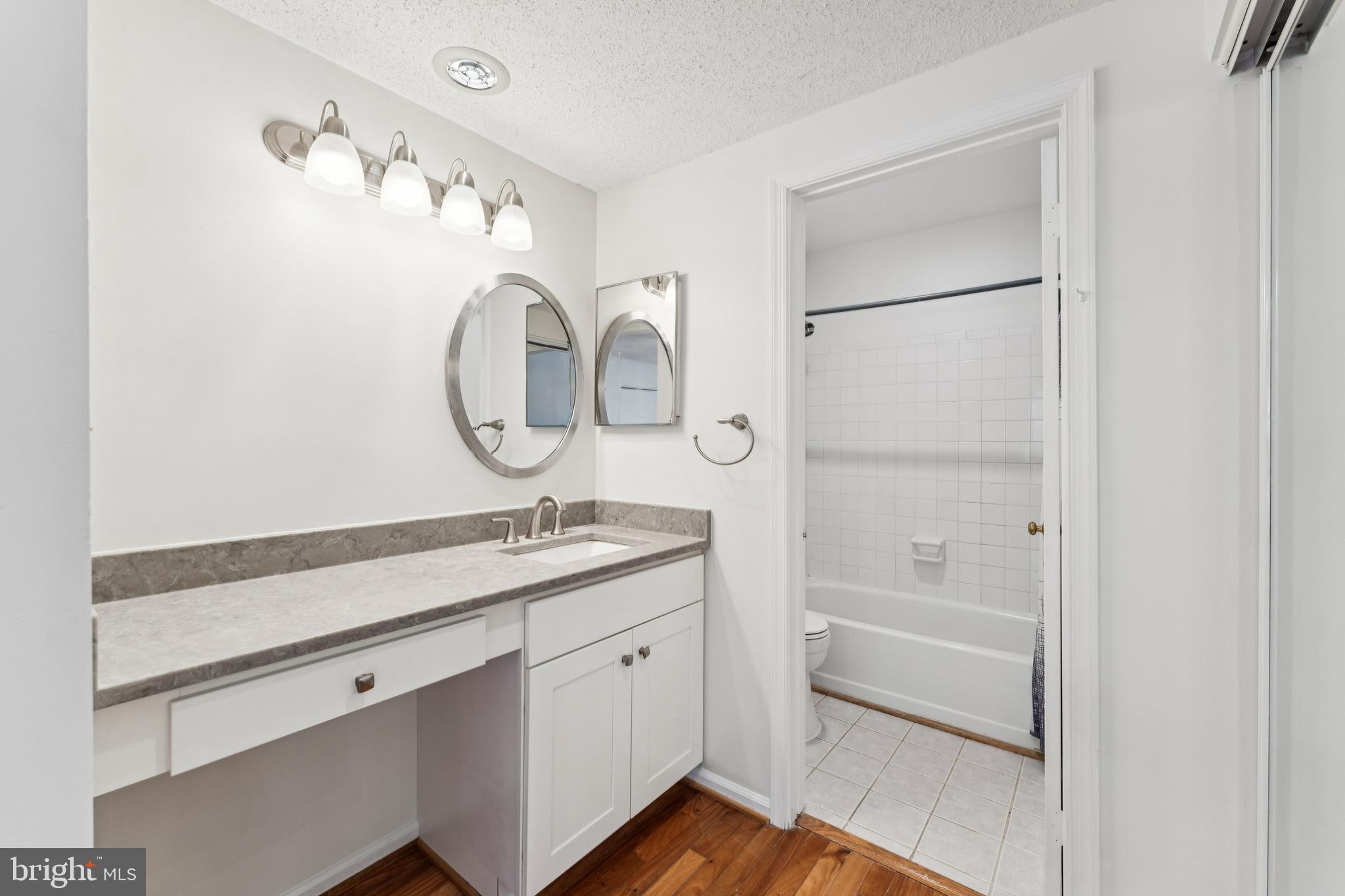 3152 B Covewood Court Falls Church, VA 22042 - Photo 10 of 26 a en suite bathroom with a granite countertop sink and a mirror