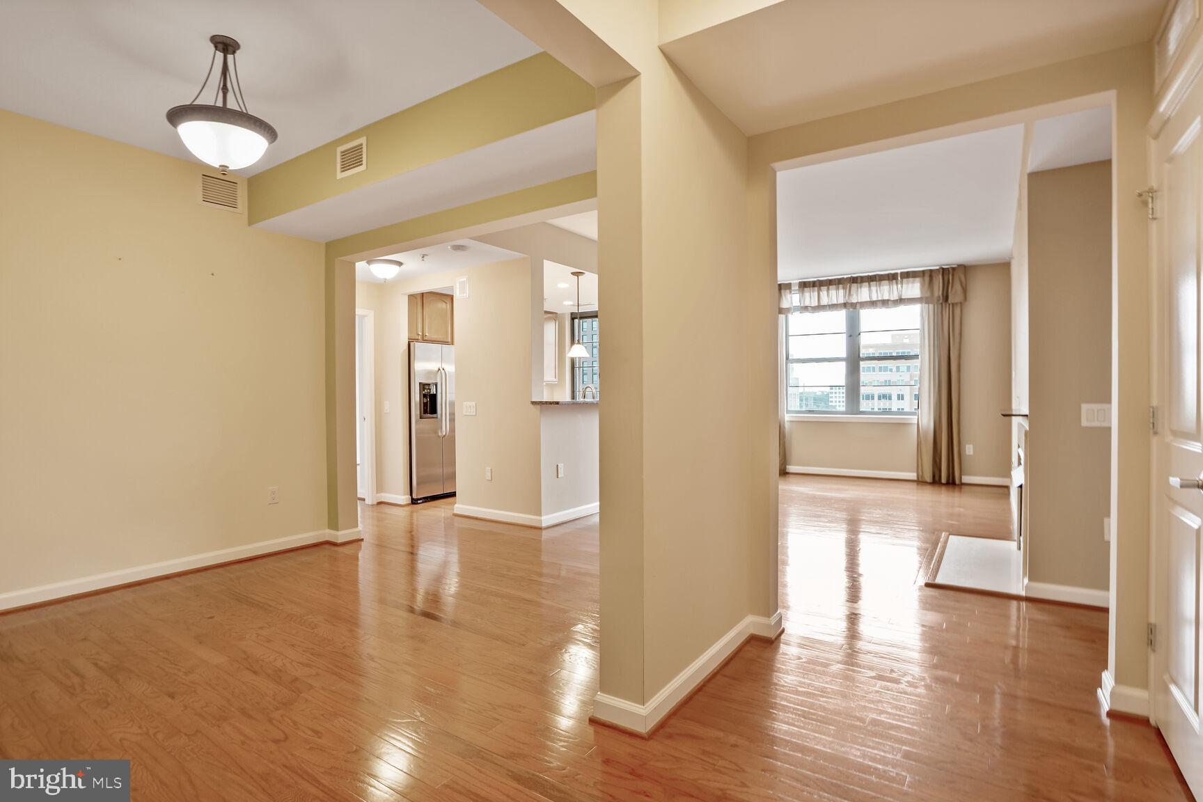 1830 Fountain Drive, Unit 1106 Reston, VA 20190 - Photo 11 of 30 a view of a hallway with wooden floor and chandelier