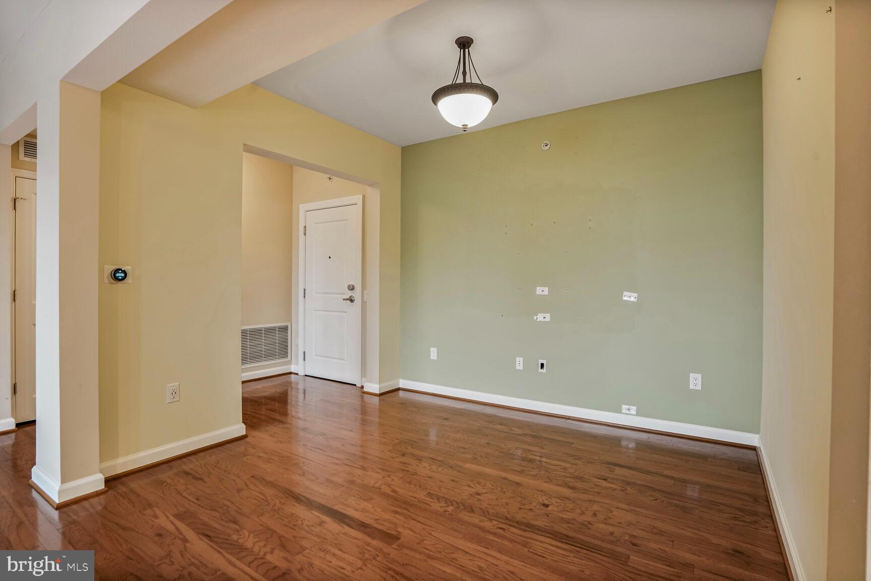 1830 Fountain Drive, Unit 1106 Reston, VA 20190 - Photo 12 of 30 wooden floor in an empty room with a window
