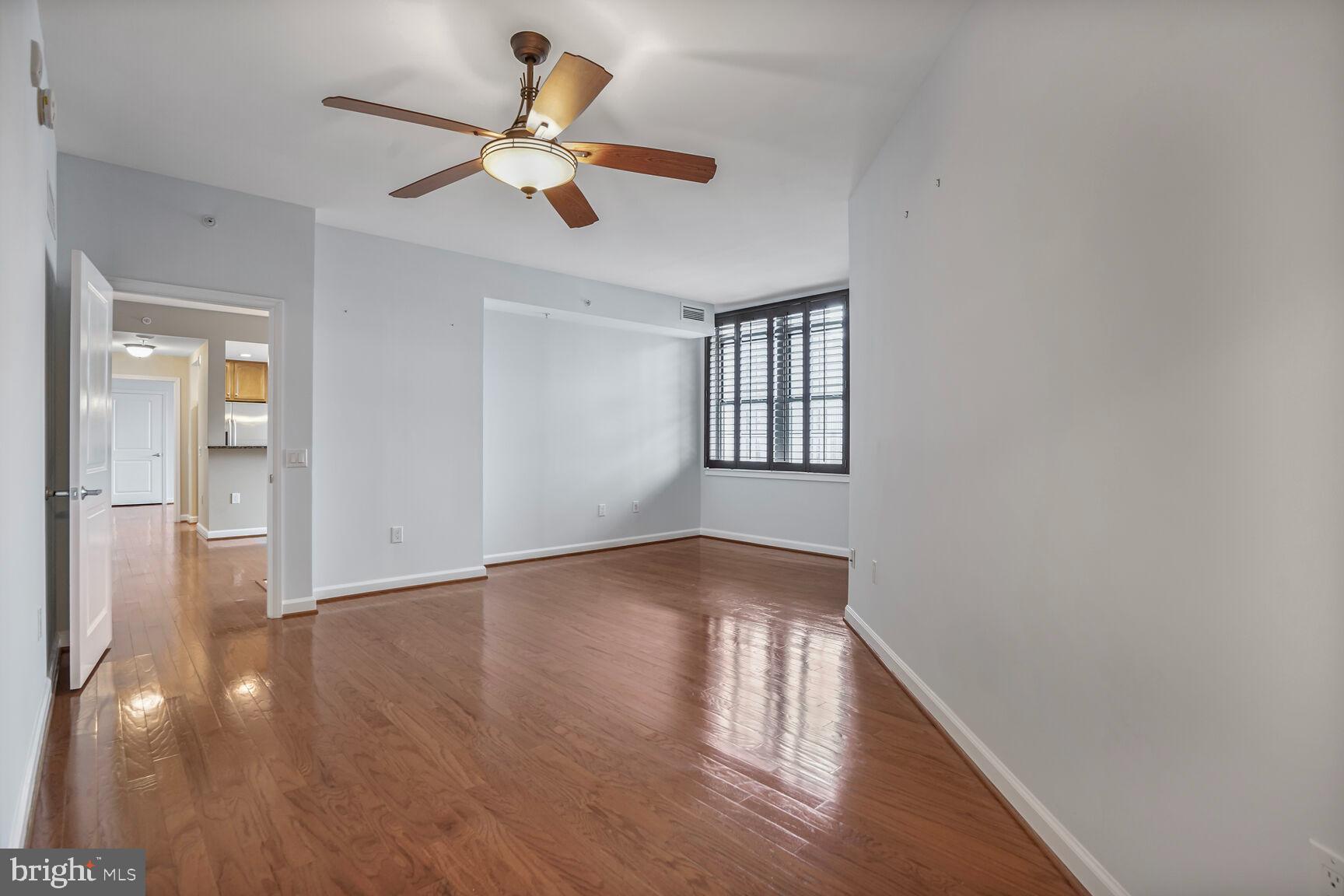 1830 Fountain Drive, Unit 1106 Reston, VA 20190 - Photo 13 of 30 a view of an empty room with window and wooden floor