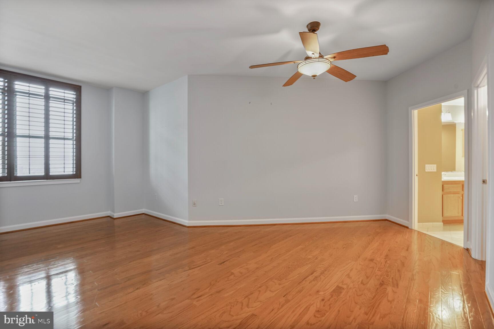 1830 Fountain Drive, Unit 1106 Reston, VA 20190 - Photo 14 of 30 a view of empty room with wooden floor and fan
