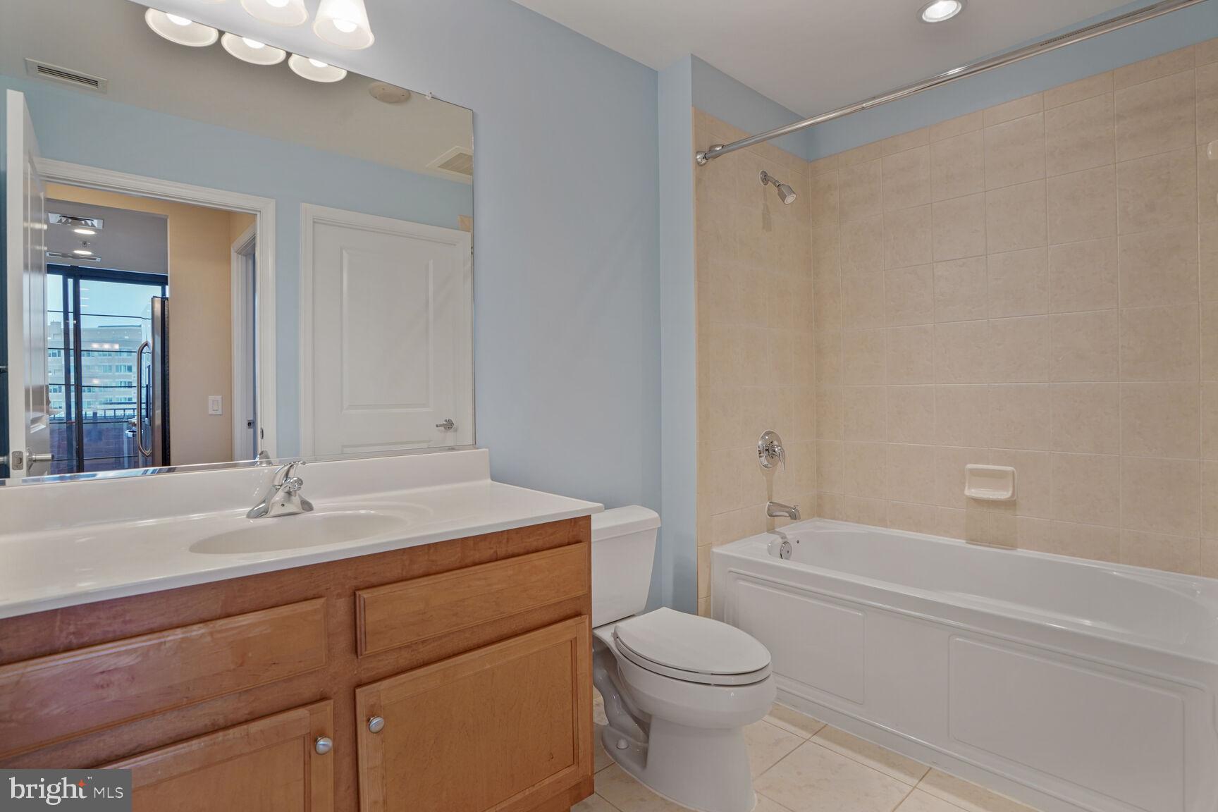 1830 Fountain Drive, Unit 1106 Reston, VA 20190 - Photo 15 of 30 a bathroom with a sink a toilet and shower