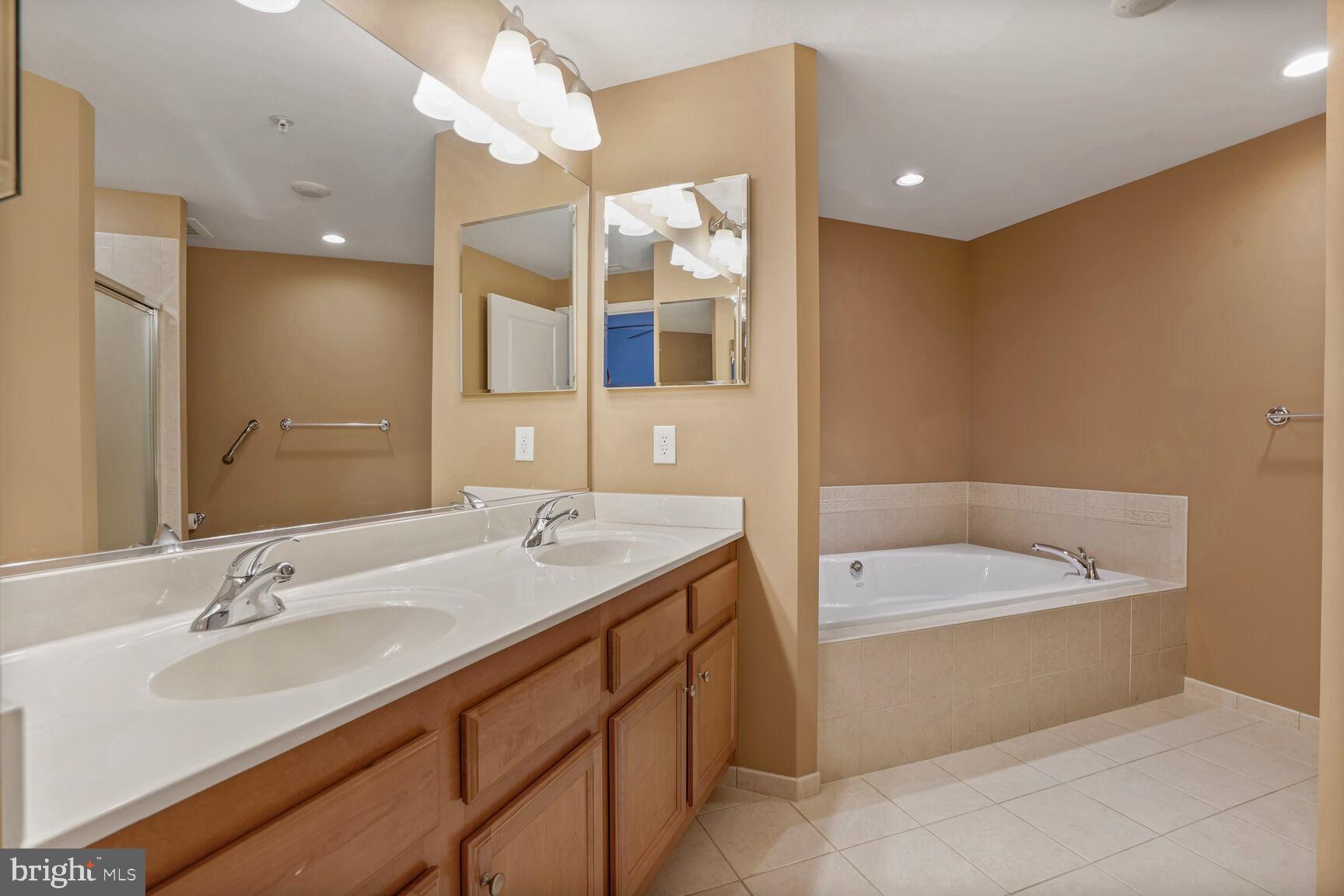 1830 Fountain Drive, Unit 1106 Reston, VA 20190 - Photo 16 of 30 a bathroom with a tub sink and mirror