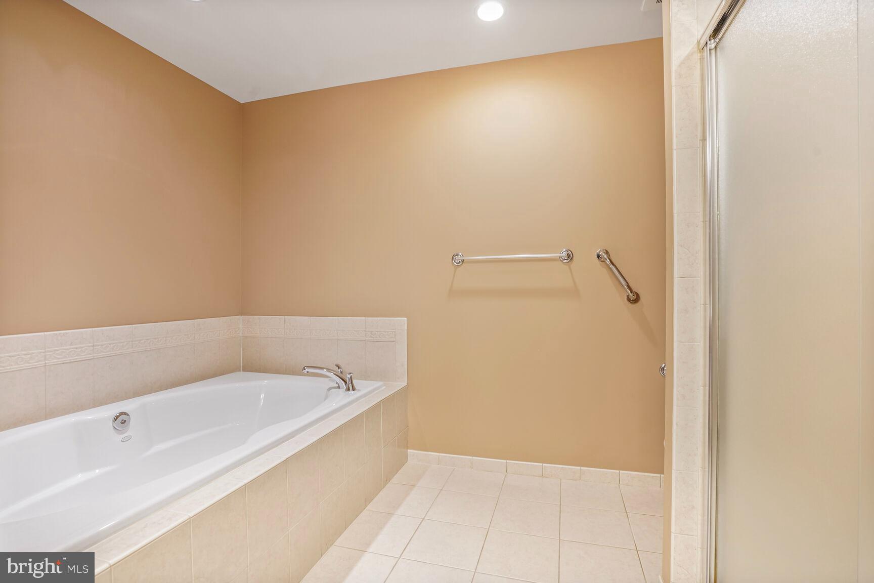 1830 Fountain Drive, Unit 1106 Reston, VA 20190 - Photo 17 of 30 a bathroom with a bathtub and shower