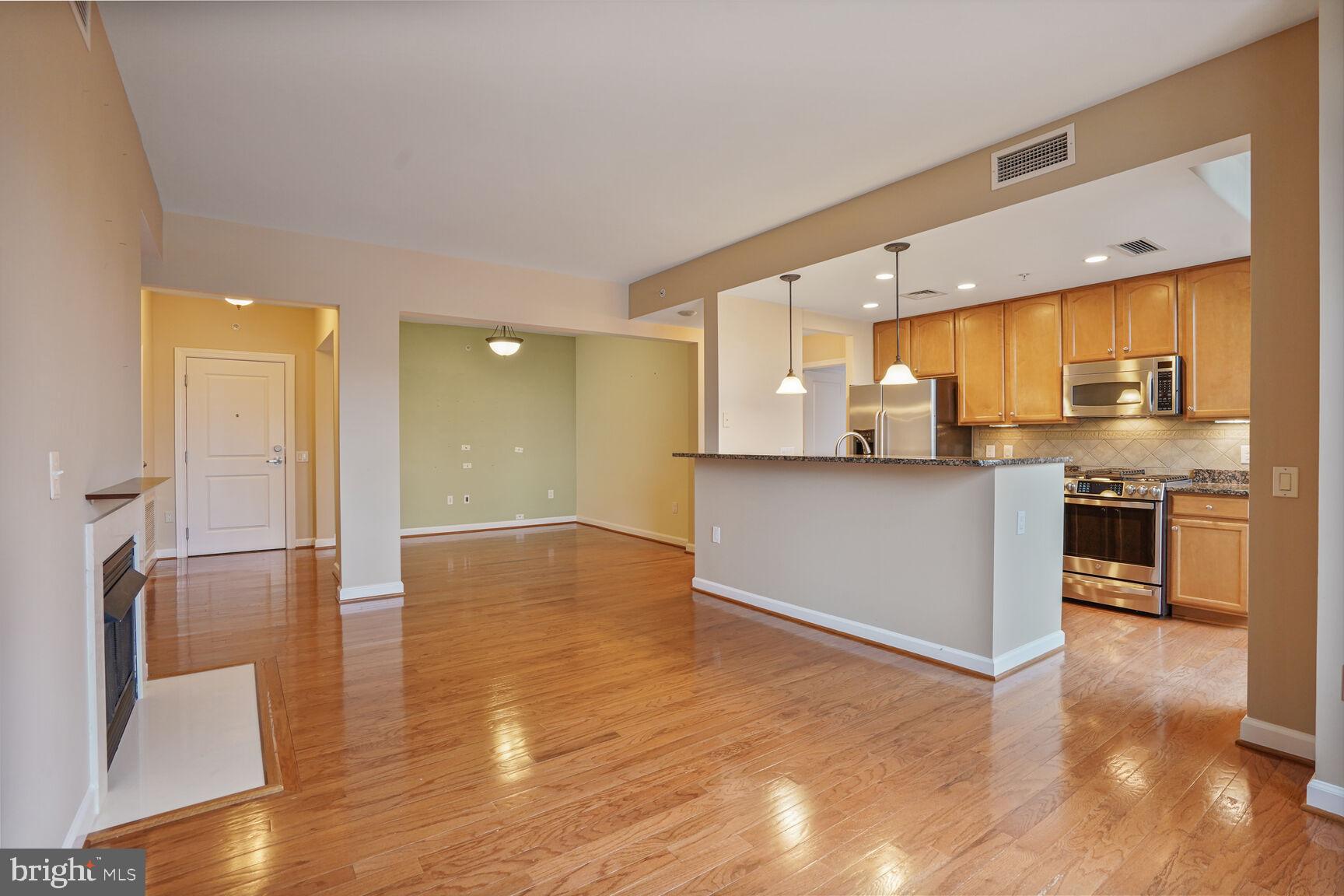 1830 Fountain Drive, Unit 1106 Reston, VA 20190 - Photo 4 of 30 a view of a kitchen with a sink and a stove top oven