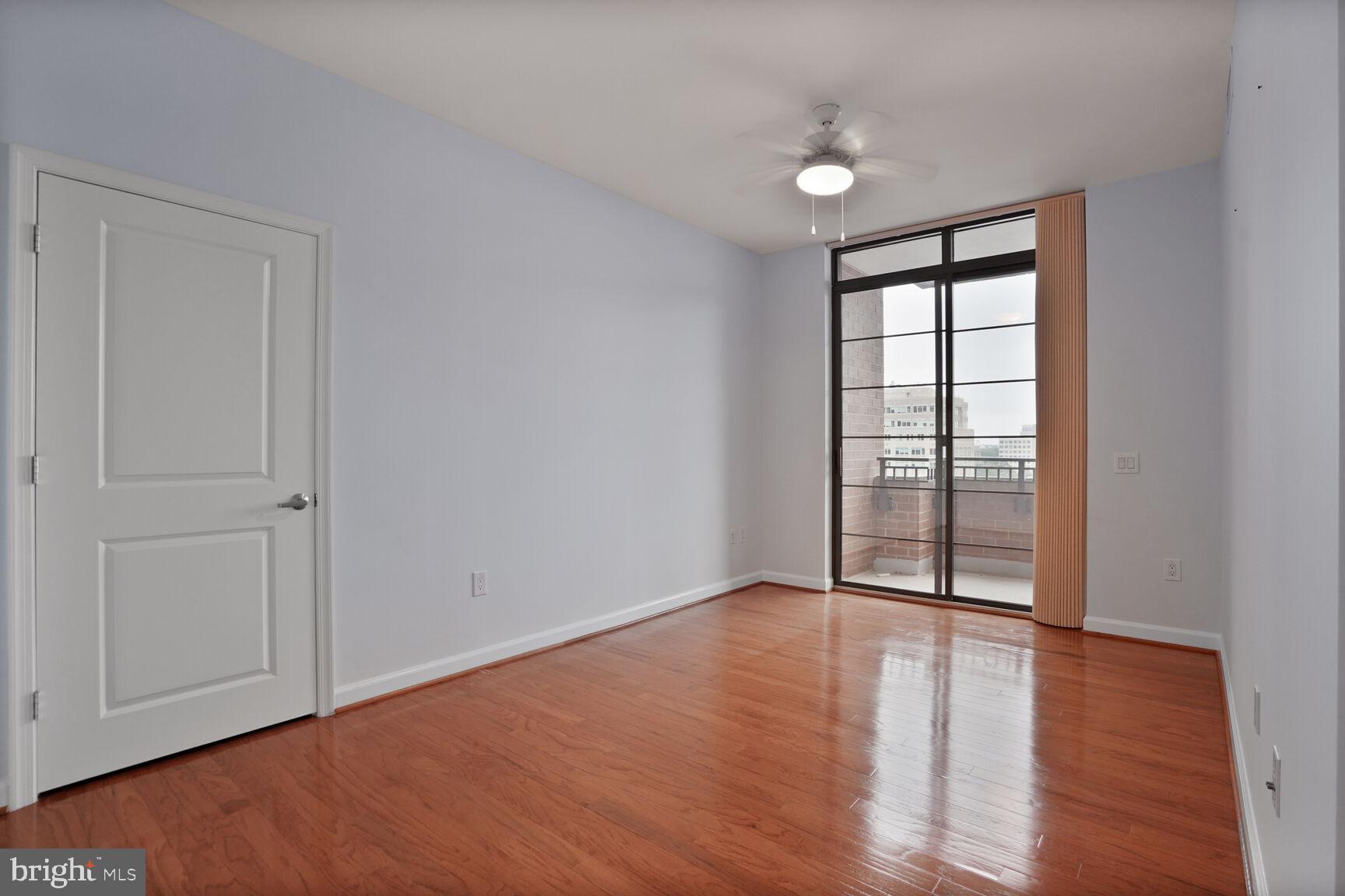 1830 Fountain Drive, Unit 1106 Reston, VA 20190 - Photo 9 of 30 wooden floor in an empty room with a window