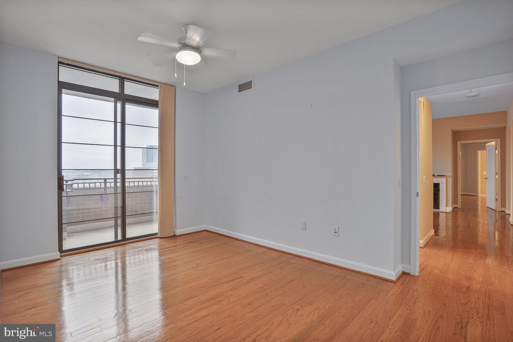 1830 Fountain Drive, Unit 1106 Reston, VA 20190 - Photo 10 of 30 wooden floor in an empty room with a window