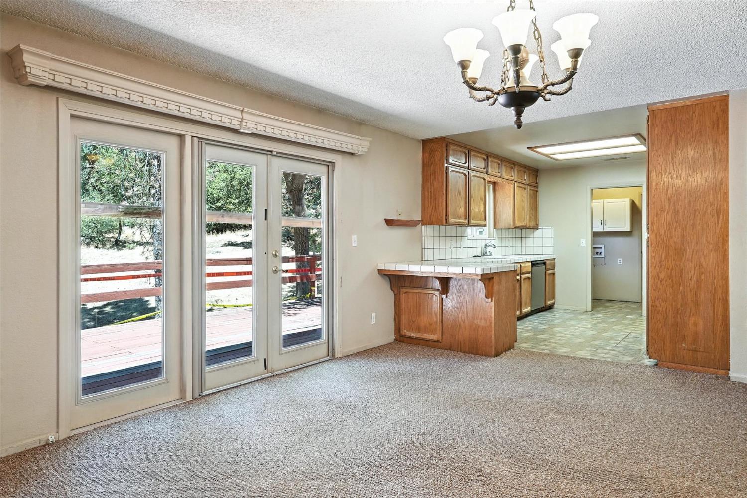 5783 Chowchilla Mountain Road Mariposa, CA 95338 - Photo 14 of 43 a large kitchen with stainless steel appliances granite countertop a stove and a chandelier
