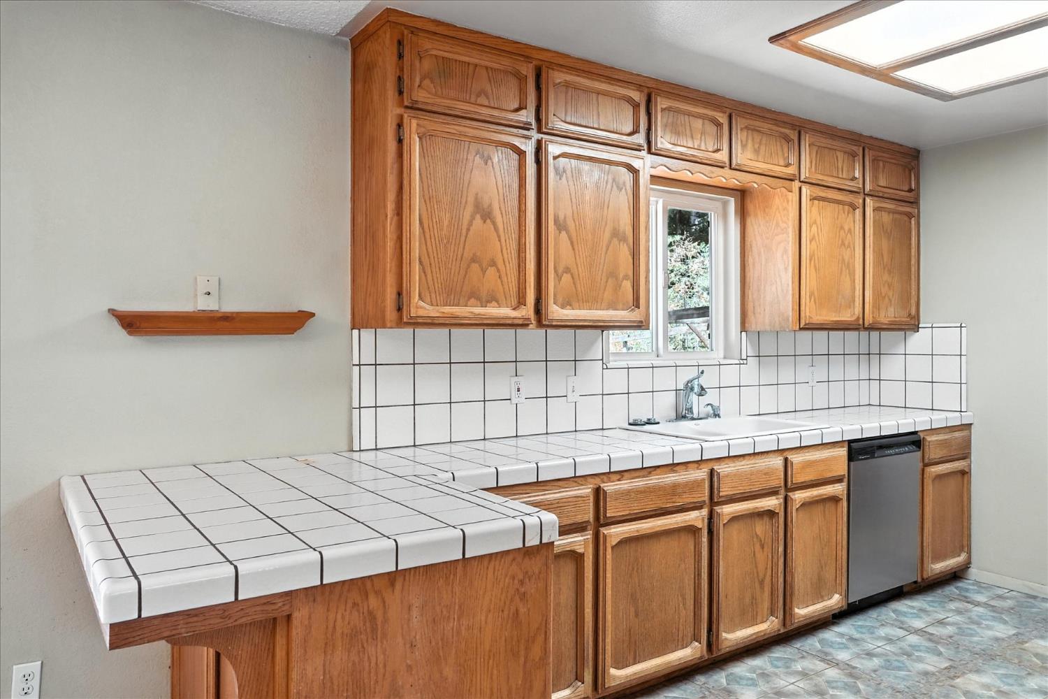 5783 Chowchilla Mountain Road Mariposa, CA 95338 - Photo 16 of 43 a kitchen with stainless steel appliances granite countertop a sink and cabinets with wooden floor