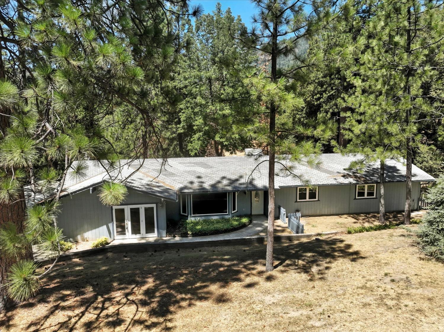5783 Chowchilla Mountain Road Mariposa, CA 95338 - Photo 2 of 43 a front view of a house with a yard