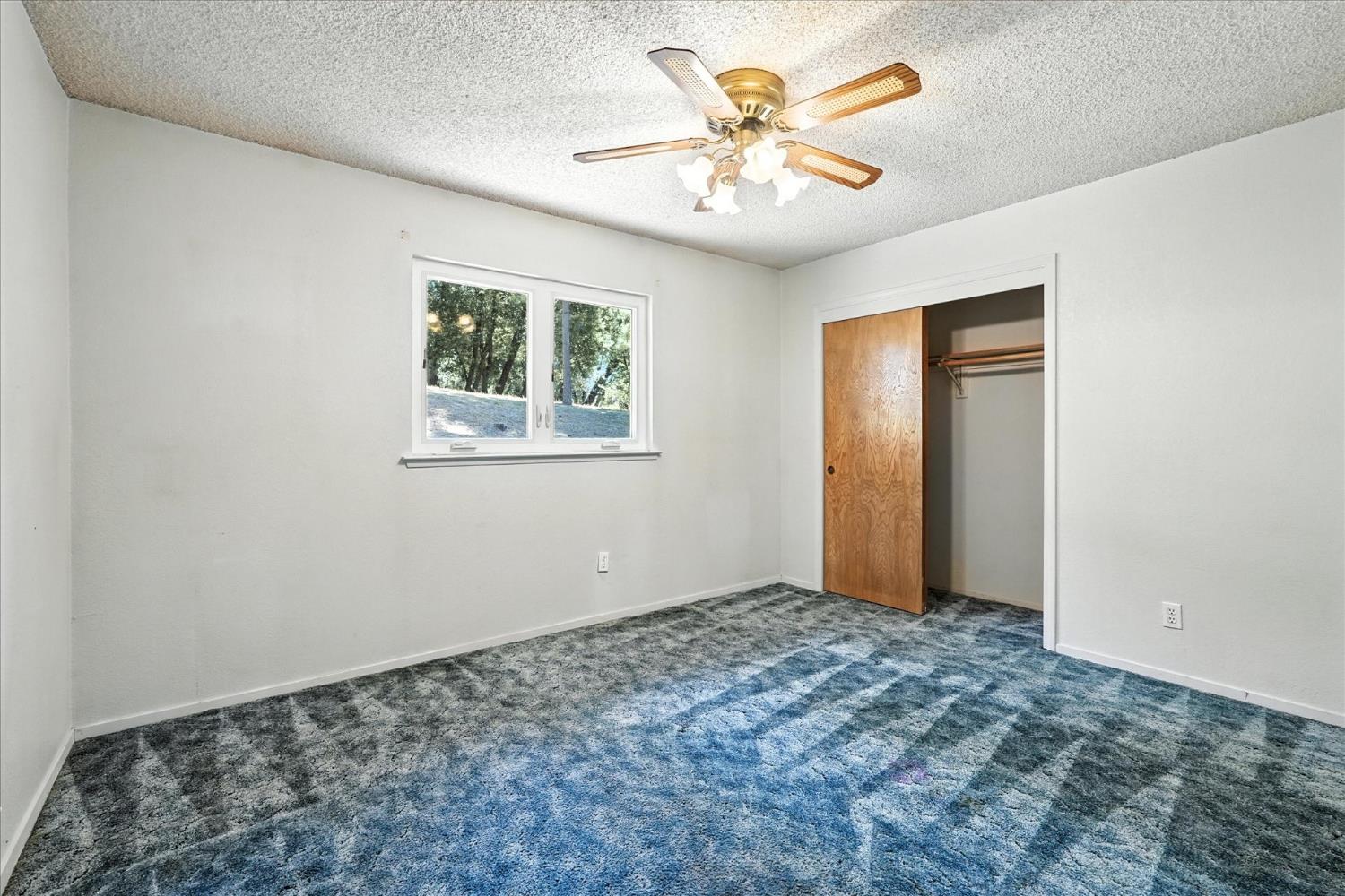 5783 Chowchilla Mountain Road Mariposa, CA 95338 - Photo 28 of 43 a view of an empty room with a window