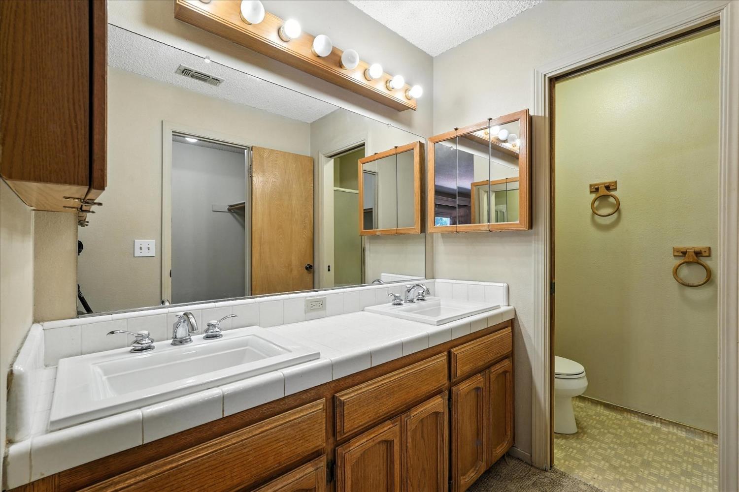 5783 Chowchilla Mountain Road Mariposa, CA 95338 - Photo 36 of 43 a bathroom with a double vanity sink and mirror
