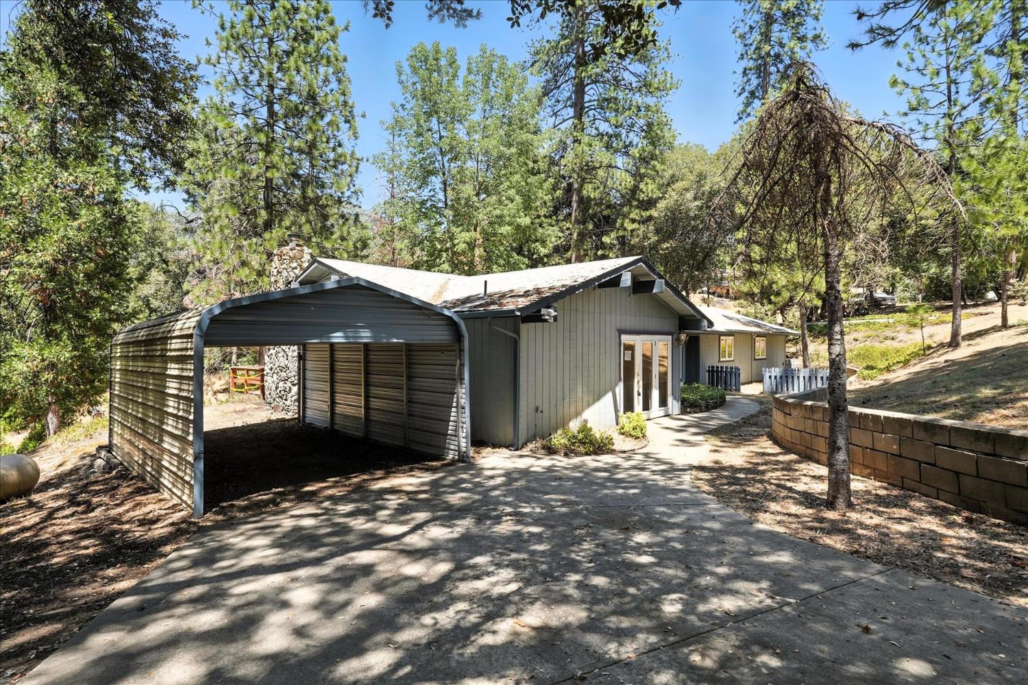 5783 Chowchilla Mountain Road Mariposa, CA 95338 - Photo 40 of 43 a front view of a house with a yard and garage